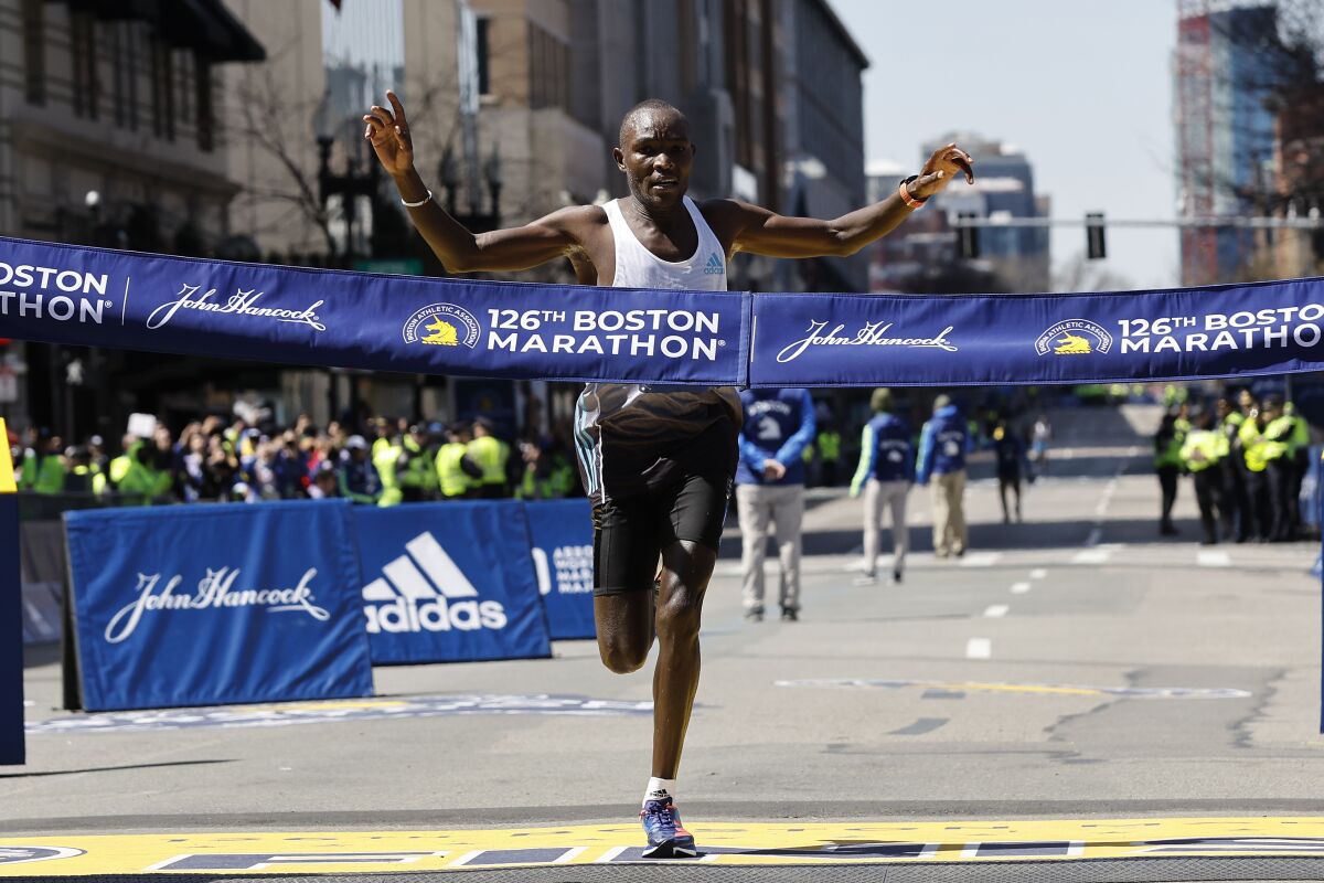 FILE - Evans Chebet, of Kenya, hits the finish line to win the 126th Boston Marathon, Monday, April 18, 2022, in Boston. The Boston Marathon has agreed to a 10-year sponsorship deal with Bank of America that organizers hope will allow the world’s oldest and most prestigious annual 26.2-mile road race to grow over the next decade while maintaining its historic character. Financial terms of the deal announced Monday, March 27, 2023, were not disclosed. (AP Photo/Winslow Townson, File)