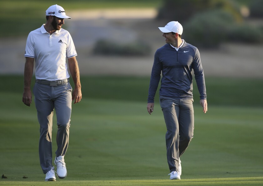 Dustin Johnson, left, and Rory McIlroy won a charity match Sunday at Seminole Golf Club in Florida, marking live golf's return to television.
