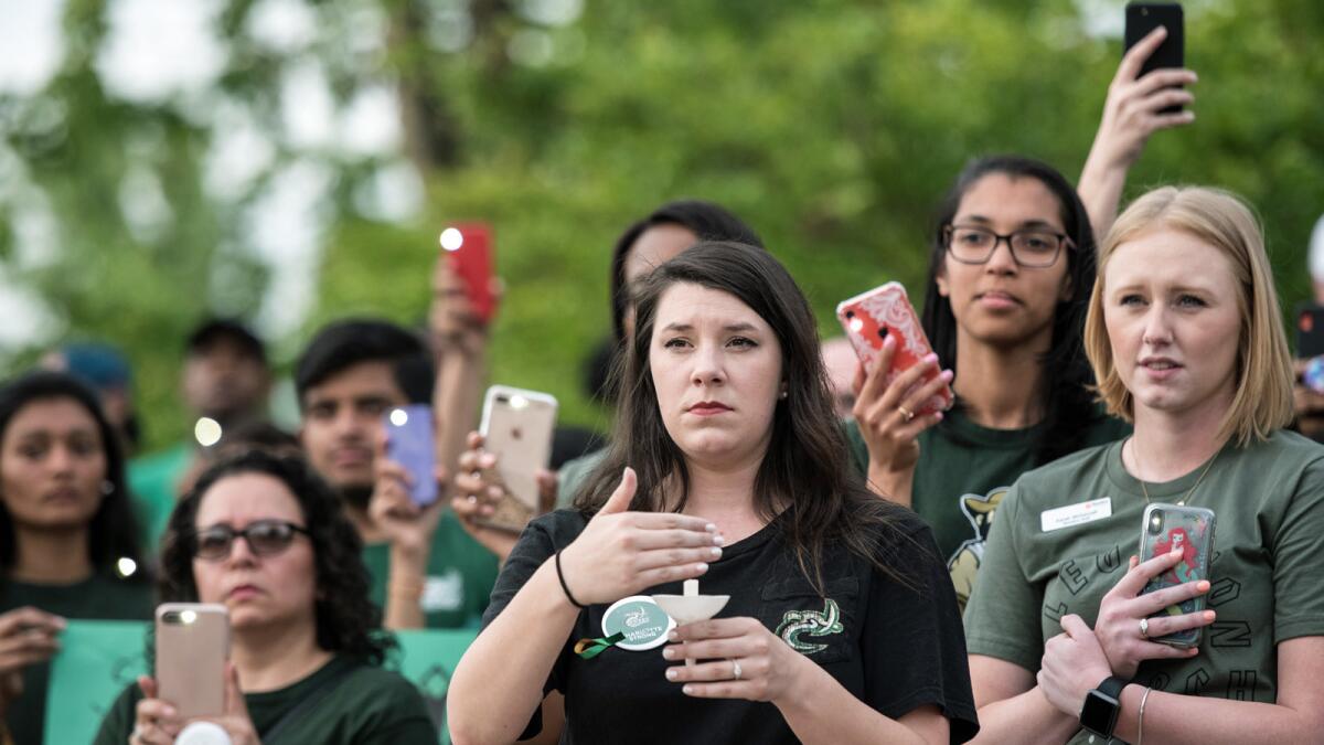 UNC Charlotte students hold a vigil the day after the shooting.