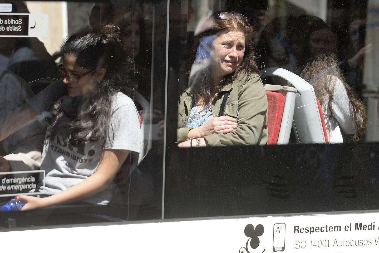 Students and parents leave the Joan Fuster Institute on a bus after a fatal attack at the high school in Barcelona, Spain, on April 20, 2015.