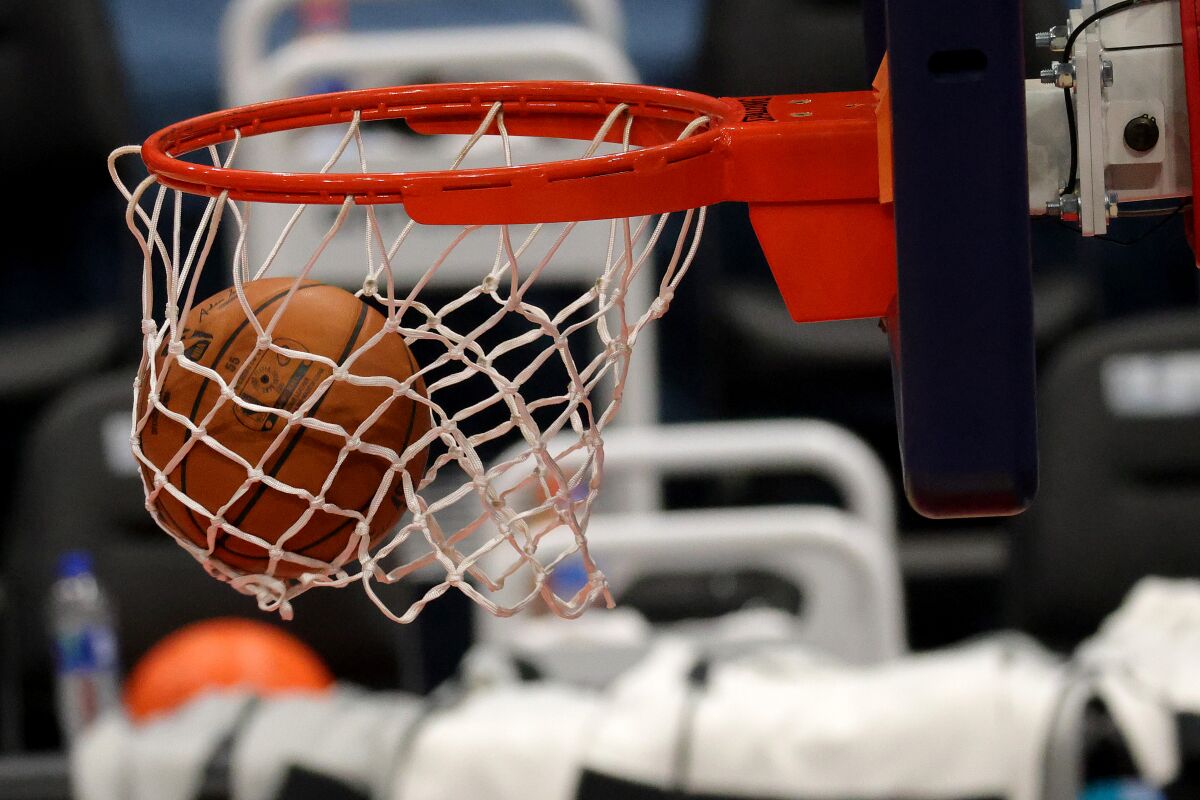 Basketballs go through the hoop during warmups of the Detroit Pistons.