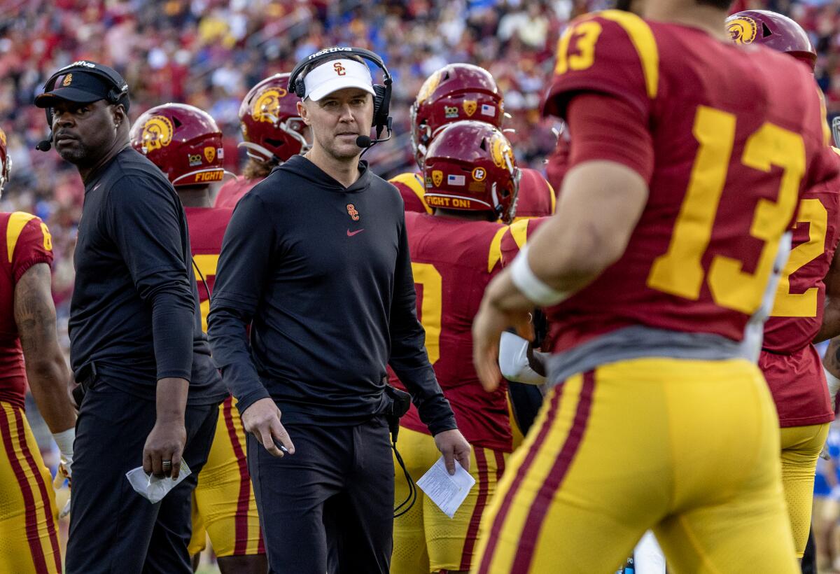 USC coach Lincoln Riley emerges from the huddle during the team's loss to UCLA 