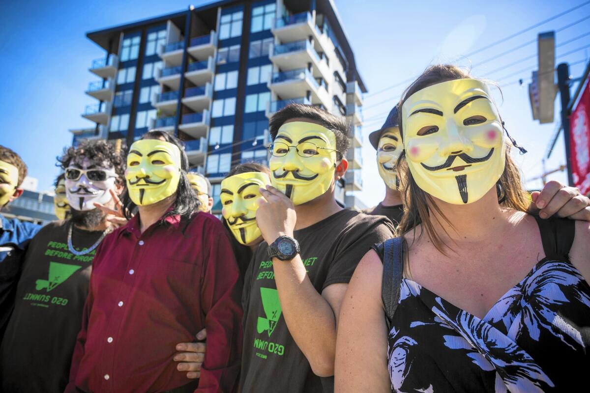 Activists with Anonymous wear Guy Fawkes masks during a gathering in Brisbane, Australia. The group prioritizes the collective over the individual.