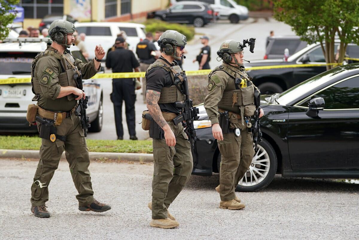 Police officers stand outside a mall.