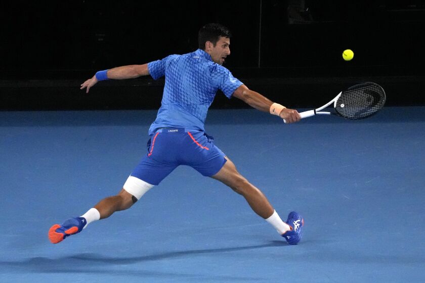 Novak Djokovic of Serbia plays a backhand return to Roberto Carballes Baena of Spain during their first round match at the Australian Open tennis championship in Melbourne, Australia, Tuesday, Jan. 17, 2023. (AP Photo/Aaron Favila)