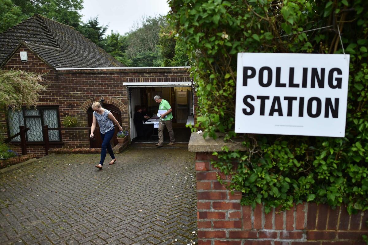 People leave after casting their ballots at a polling station in Croydon, south of London, on June 23, 2016.