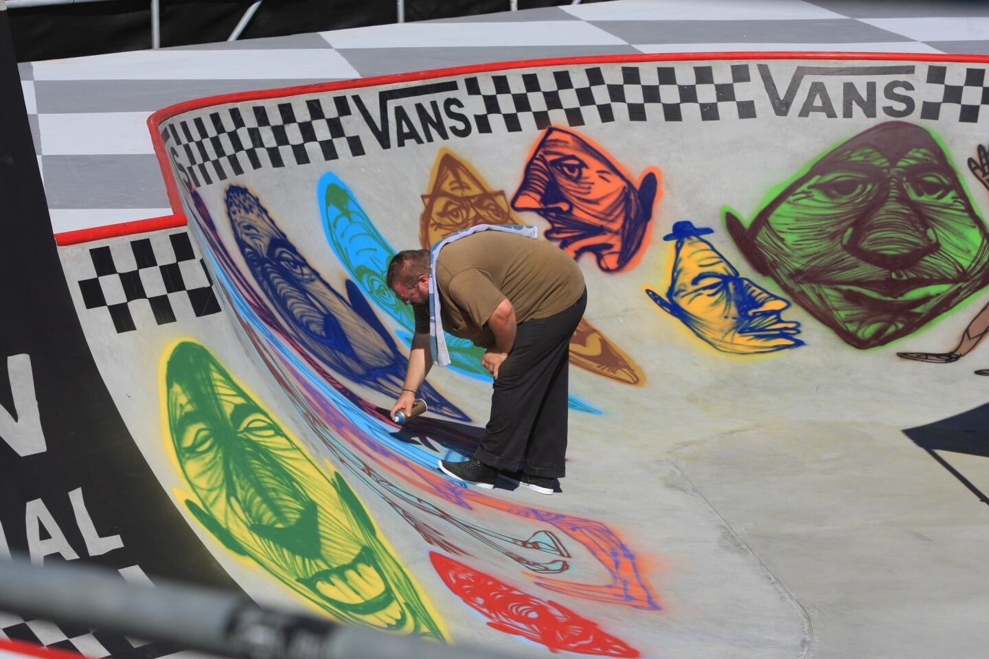 Rich Jacobs paints a mural on the Van Doren Invitational Skate Bowl competition site.