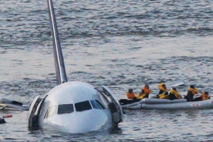 A raft leaves the US Airways jet that landed on the Hudson River in New York on Jan. 15, 2009. American Airlines helped Clint Eastwood film his movie on the crash and its aftermath, but won't show it on flights.