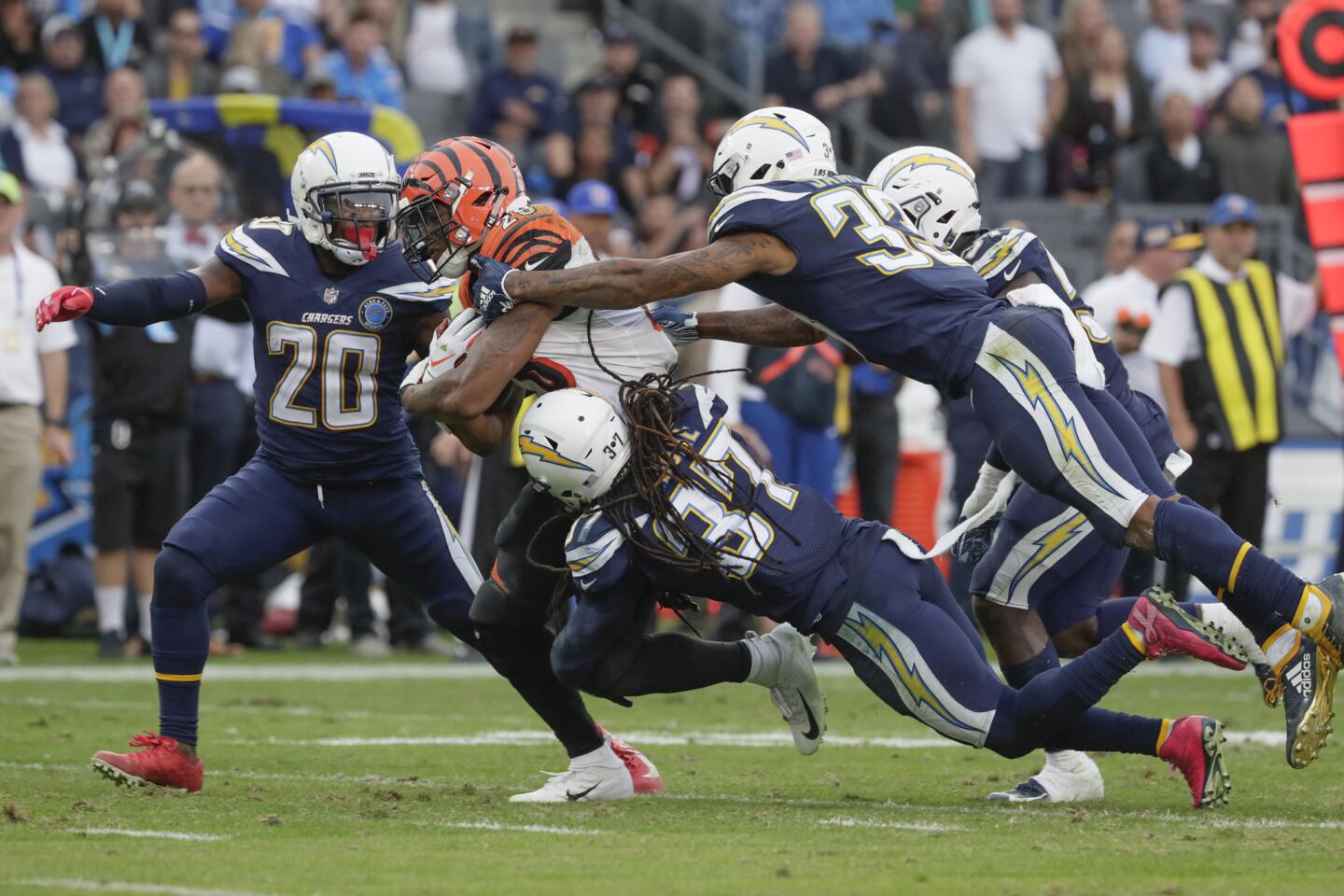 Bengals running back Joe Mixon drags Chargers defenders with him toward the first-down marker to prolong a drive in the fourth quarter.