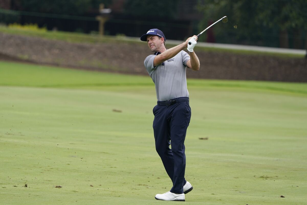 Webb Simpson hits from the fairway on the eighth hole during the first round of the Wyndham Championship golf tournament at Sedgefield Country Club on Thursday, Aug. 13, 2020, in Greensboro, N.C. (AP Photo/Chris Carlson)