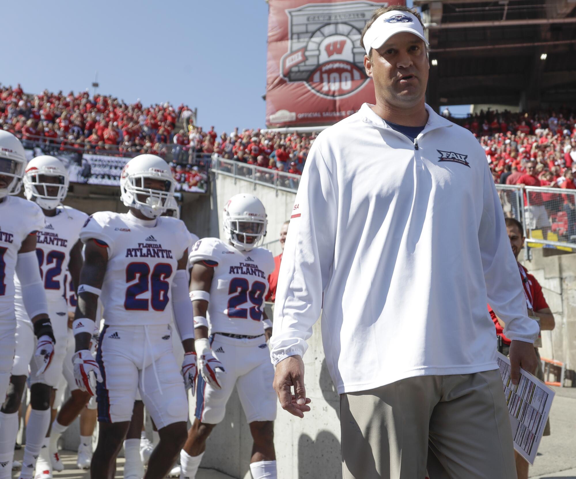 Florida Atlantic coach Lane Kiffin leads his team on the field before a game against Wisconsin.