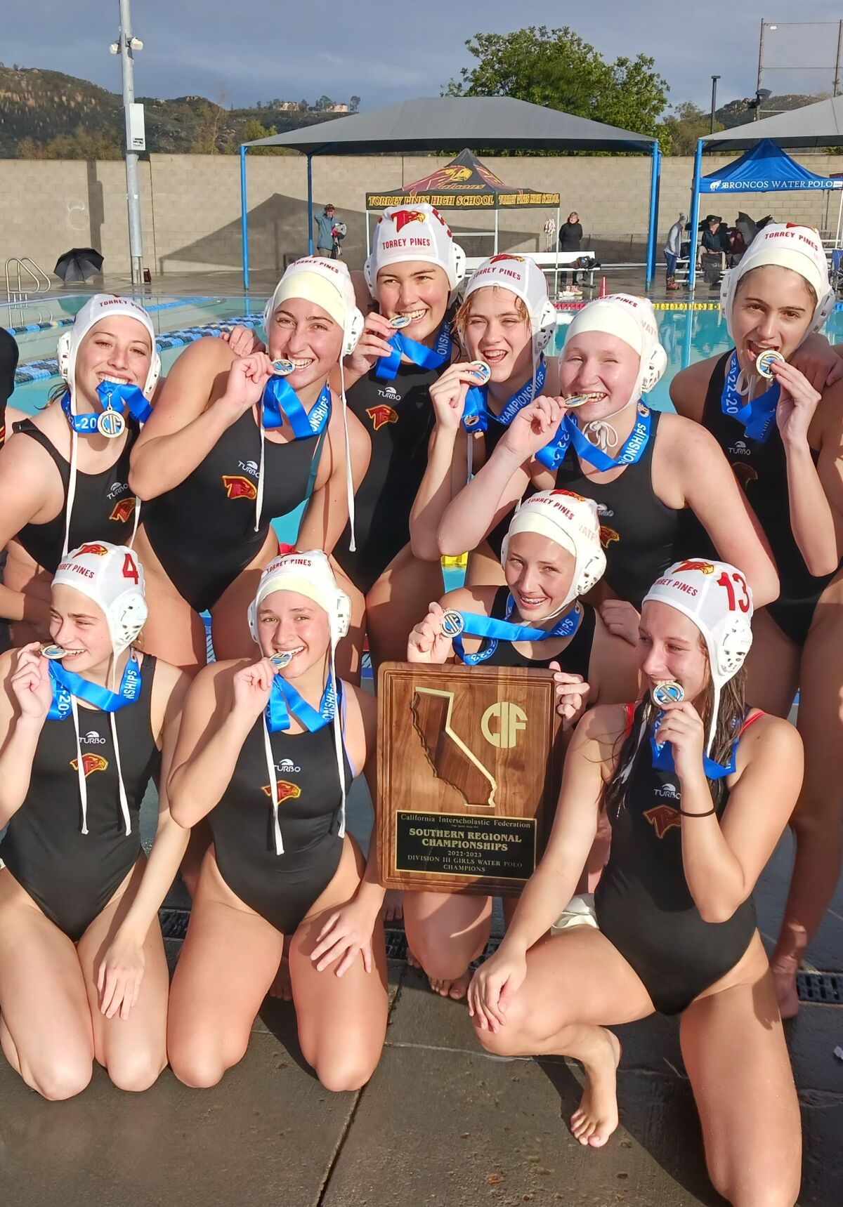 The Torrey Pines girls show off their medals and plaque for winning the Southern California Regional Division III crown.