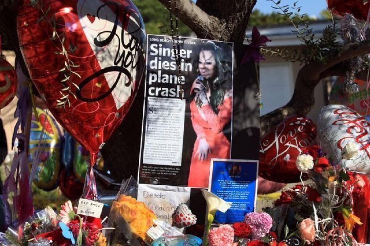 A memorial grows for singer Jenni Rivera outside her family's home in Lakewood.