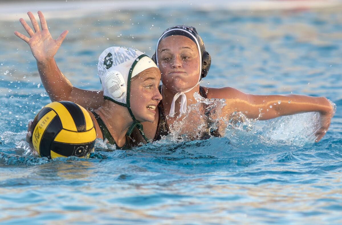 Huntington Beach's Ryan Flory defends against Santa Barbara's Abigail Webber.