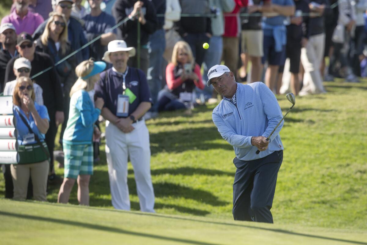 Fred Couples chips the ball onto the green of the 15th hole during the 2020 Hoag Classic.