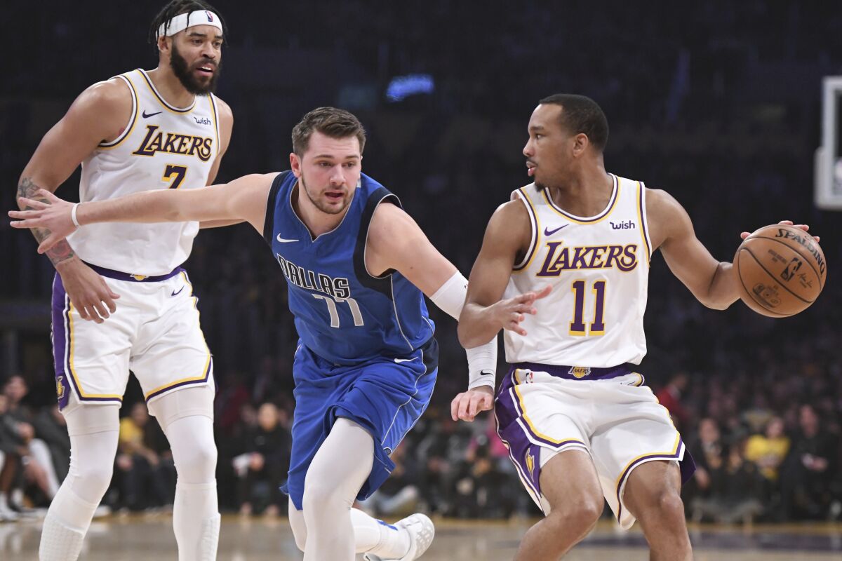 Dallas Mavericks guard Luka Doncic defends Lakers guard Avery Bradley.