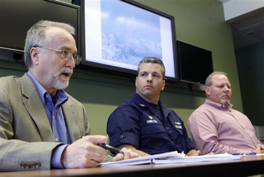 Gary Folley, with the Alaska Dept. of Environmental Conservation, left, Capt. Mark Hamilton, with the Coast Guard and Rod Ficker, with the Cook Inlet Pipeline Co., right answers questions during a news conference in Anchorage, Alaska Thursday, April 2, 2009, about the Coast Guard and state officials plans to draw down 6 million gallons of oil stored at a facility 20 miles from the still-erupting Mount Redoubt. (AP Photo/Al Grillo)