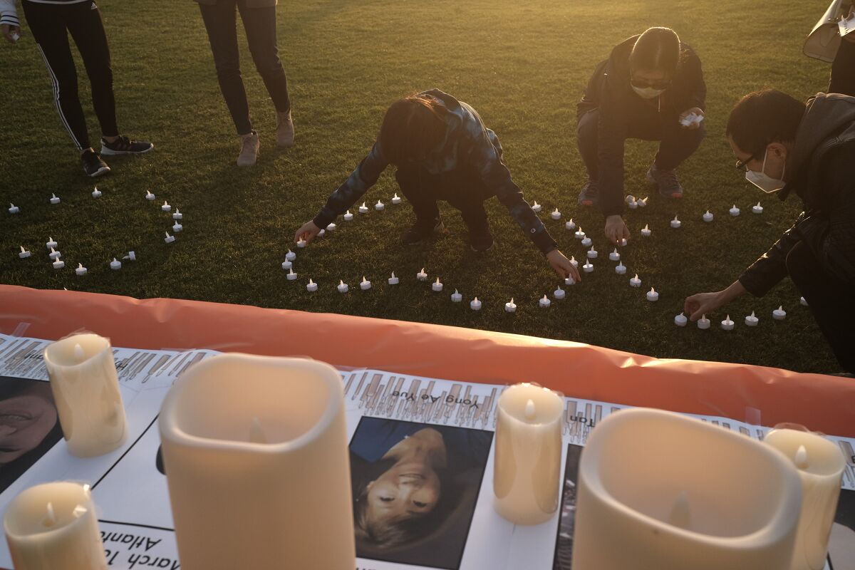 Members of San Diego's Asian community turned out with flowers and candles to remember those who were killed in Georgia