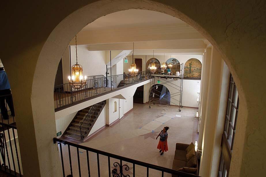 A view of the lobby at the Dunbar Hotel, where artists can be seen restoring an old Southwest mural. The hotel was built in 1928. It's being renovated as a senior-living facility.