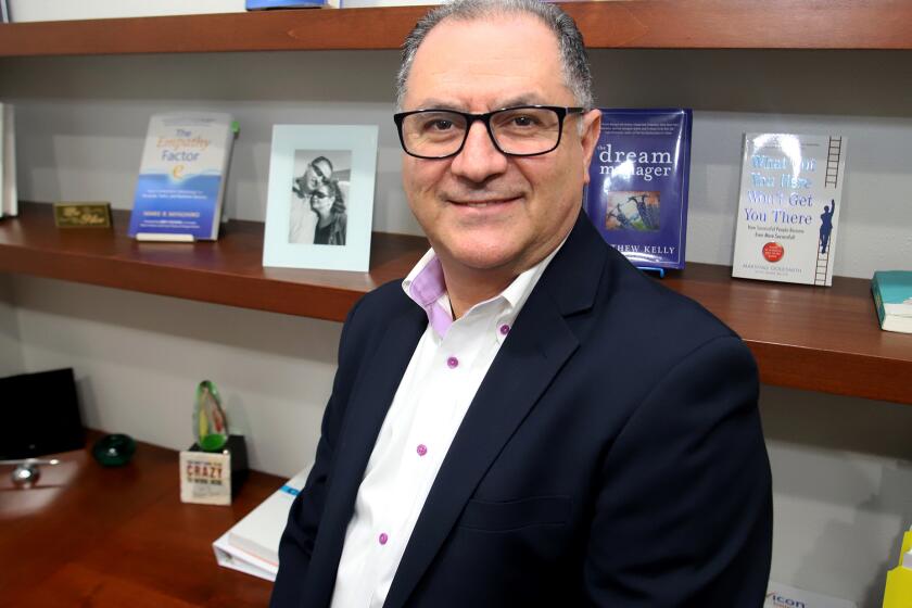 Enio Martinez the Vice President of Servicon, a cleaning service for the aero space industry, hospitals, hotels and oil companies, poses for a picture in his office at Servicon in Culver City, on Thursday, January 5, 2023. Enio Martinez came undocumented to the United States from Guatemala when he was 18, he started selling ice cream at a Thrifty Drug store in Los Angeles and then worked as a janitor. Enio believes in, "lots of hard work and lots of learning."