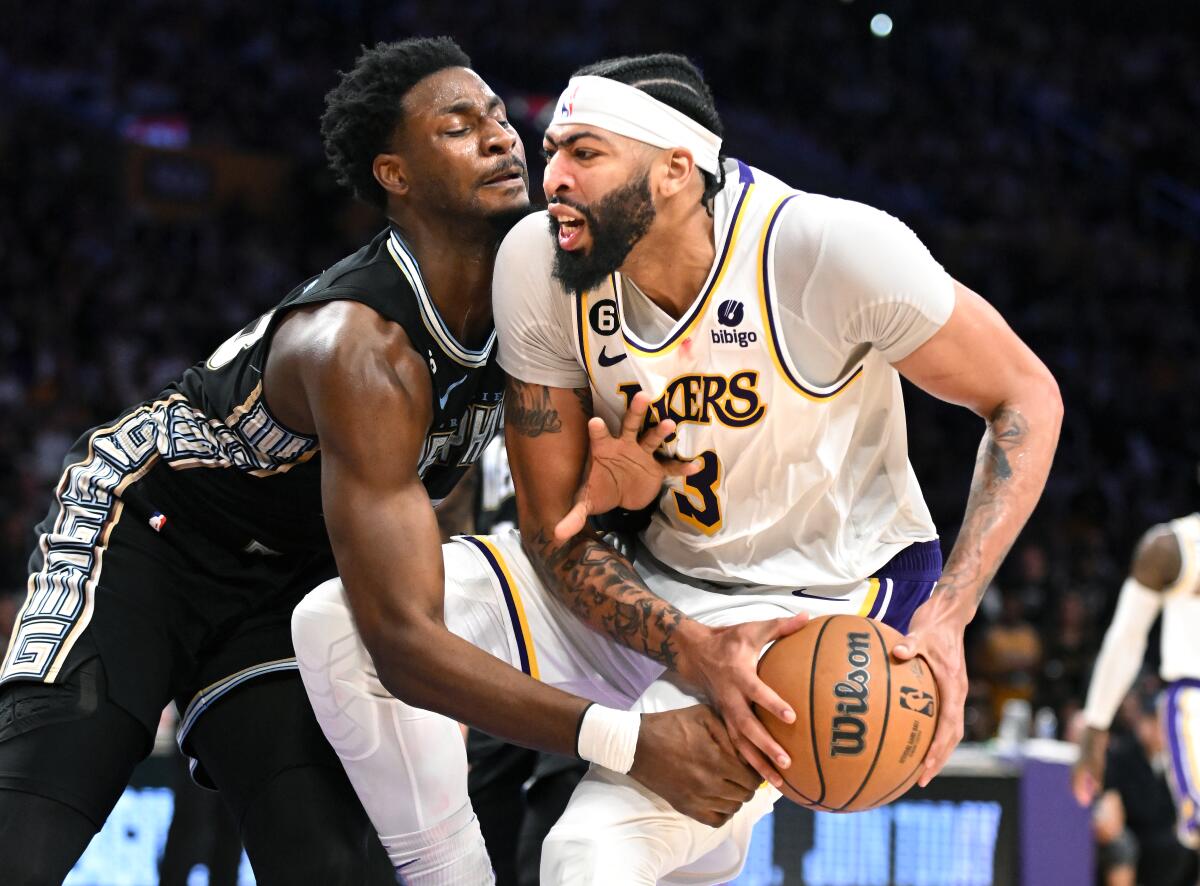 Lakers star Anthony Davis drives to the basket as Memphis Grizzlies forward Jaren Jackson Jr. tries to steal the ball.