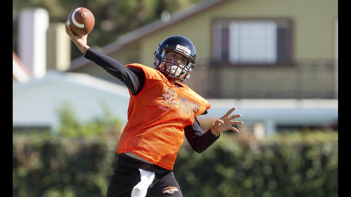 Los Amigos High quarterback Brandon Tinoco throws the ball during practice on Monday in Fountain Valley. (Kevin Chang/ Daily Pilot)