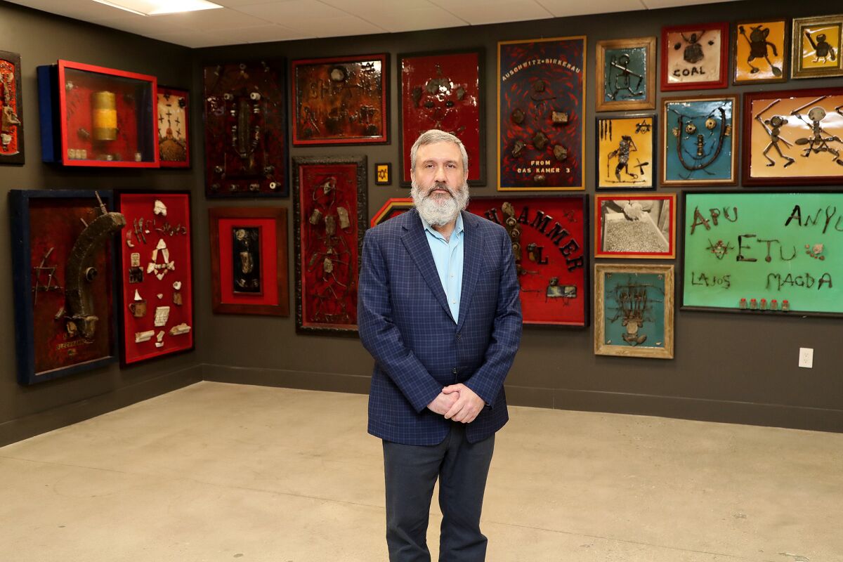 Rabbi Reuven Mintz stands inside the Mermelstein exhibit 