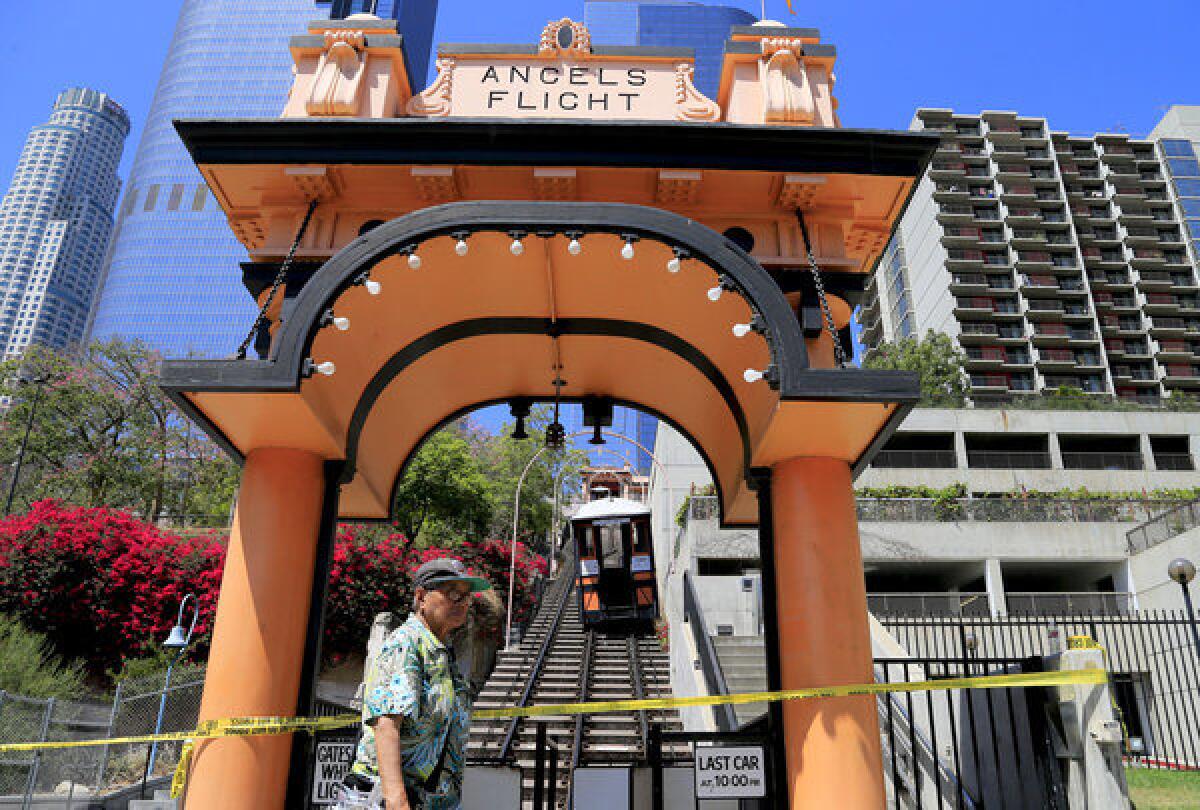 Pedestrians stroll past Angels Flight after one of the railway's lcars jumped the tracks in downtown Los Angeles.