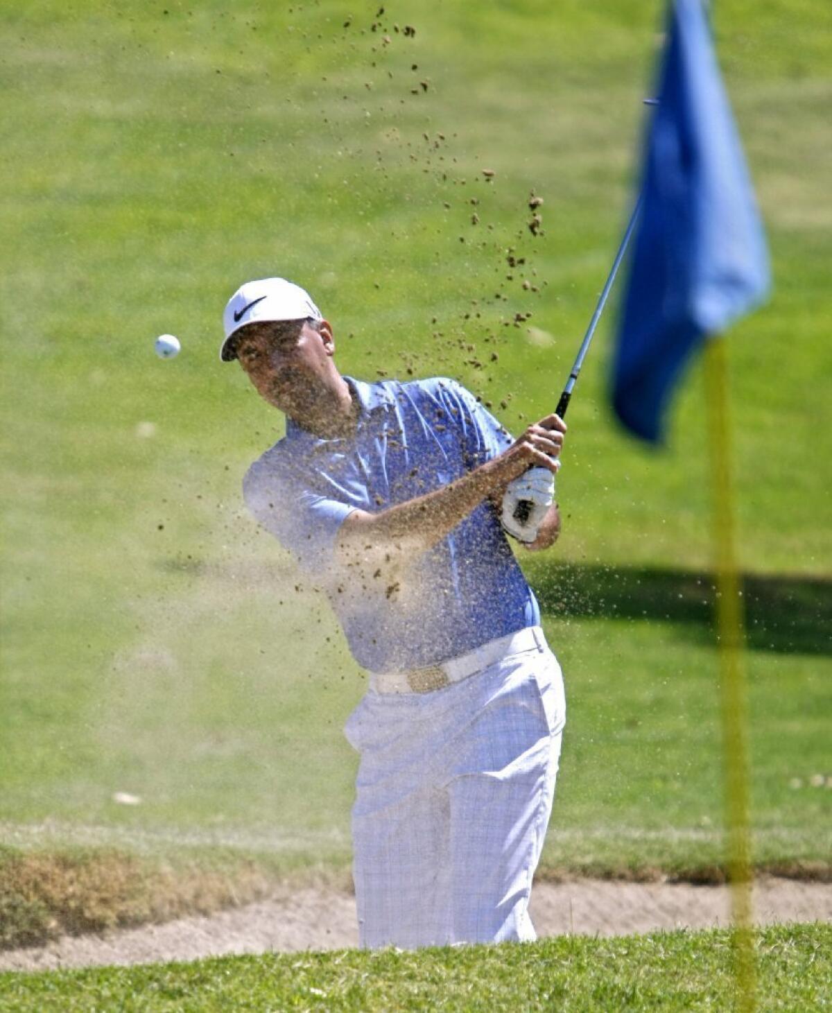 Se Chavez of Altadena shoots out of a sand trap during the Glendale City Golf Championship at Scholl Canyon Golf Course.