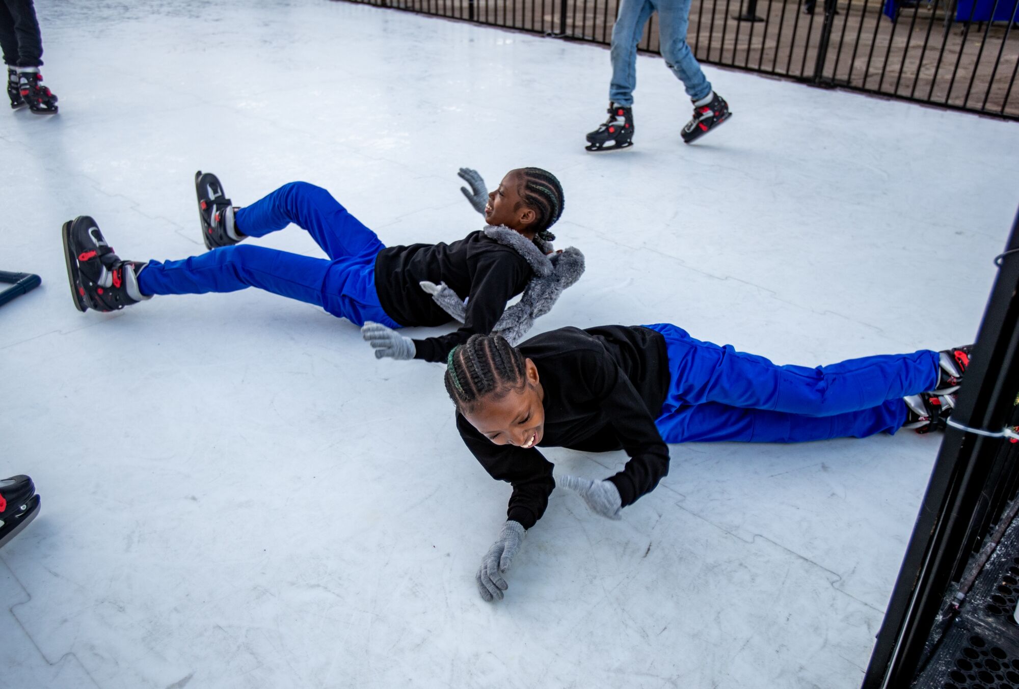 La'Veyah Mosley, 12, front, and her twin La'Niyah both loose their balance at the same time while ice skating skating 