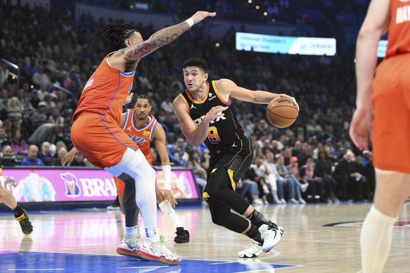 Phoenix Suns guard Grayson Allen, right,drives past Oklahoma City Thunder forward Jaylin Williams, left, during the first half of an NBA basketball game Friday, March 29, 2024, in Oklahoma City. (AP Photo/Kyle Phillips)