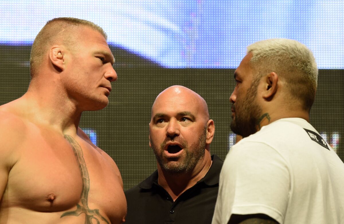 UFC President Dana White stands between fighters Brock Lesnar, left, and Mark Hunt during their weigh-in for UFC 200 on July 8.