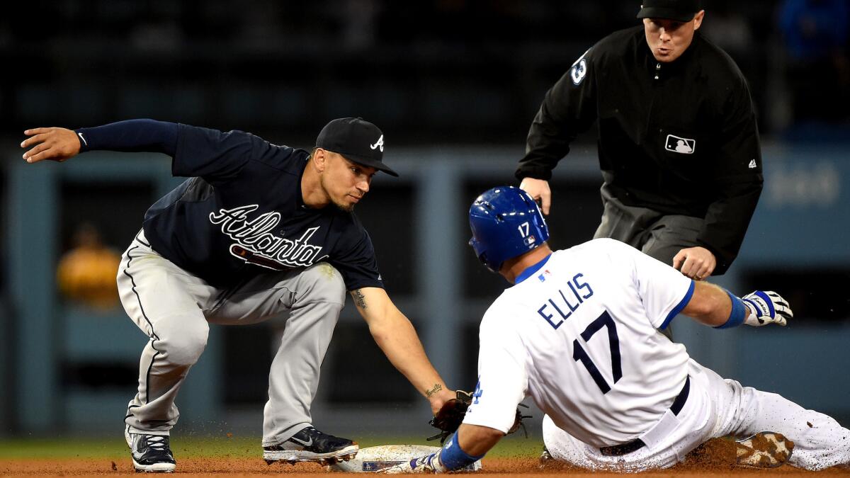 Braves shortstop Andrelton Simmons tags out Dodgers catcher A.J. Ellis, who was trying to stretch a hit into a double in the fifth inning Wednesday night.