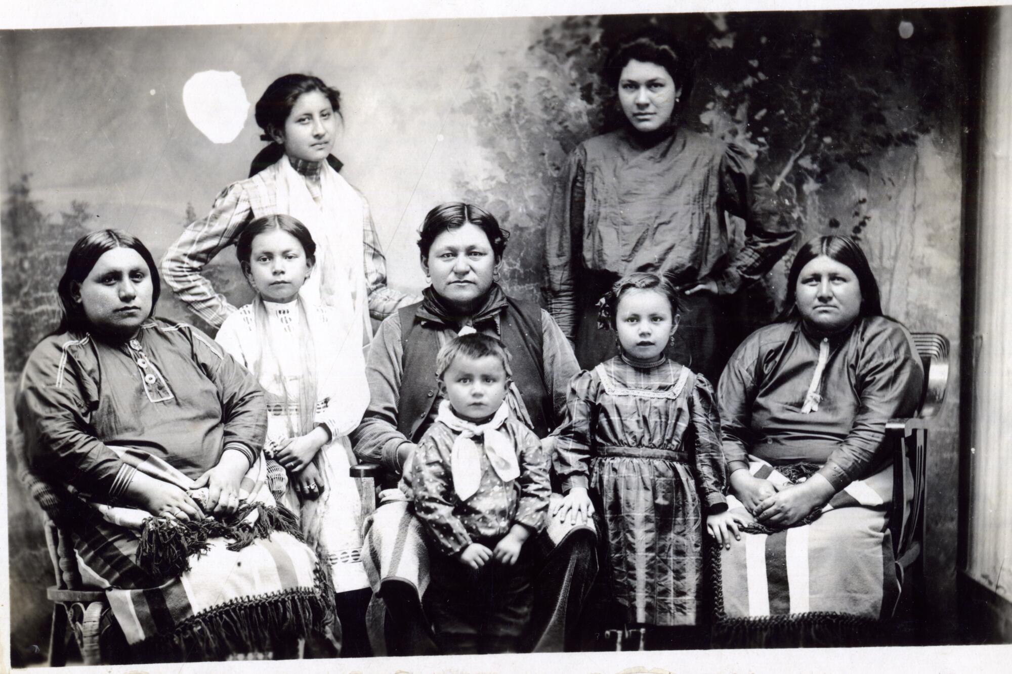A postcard shows a group of women and children of the Osage Nation.
