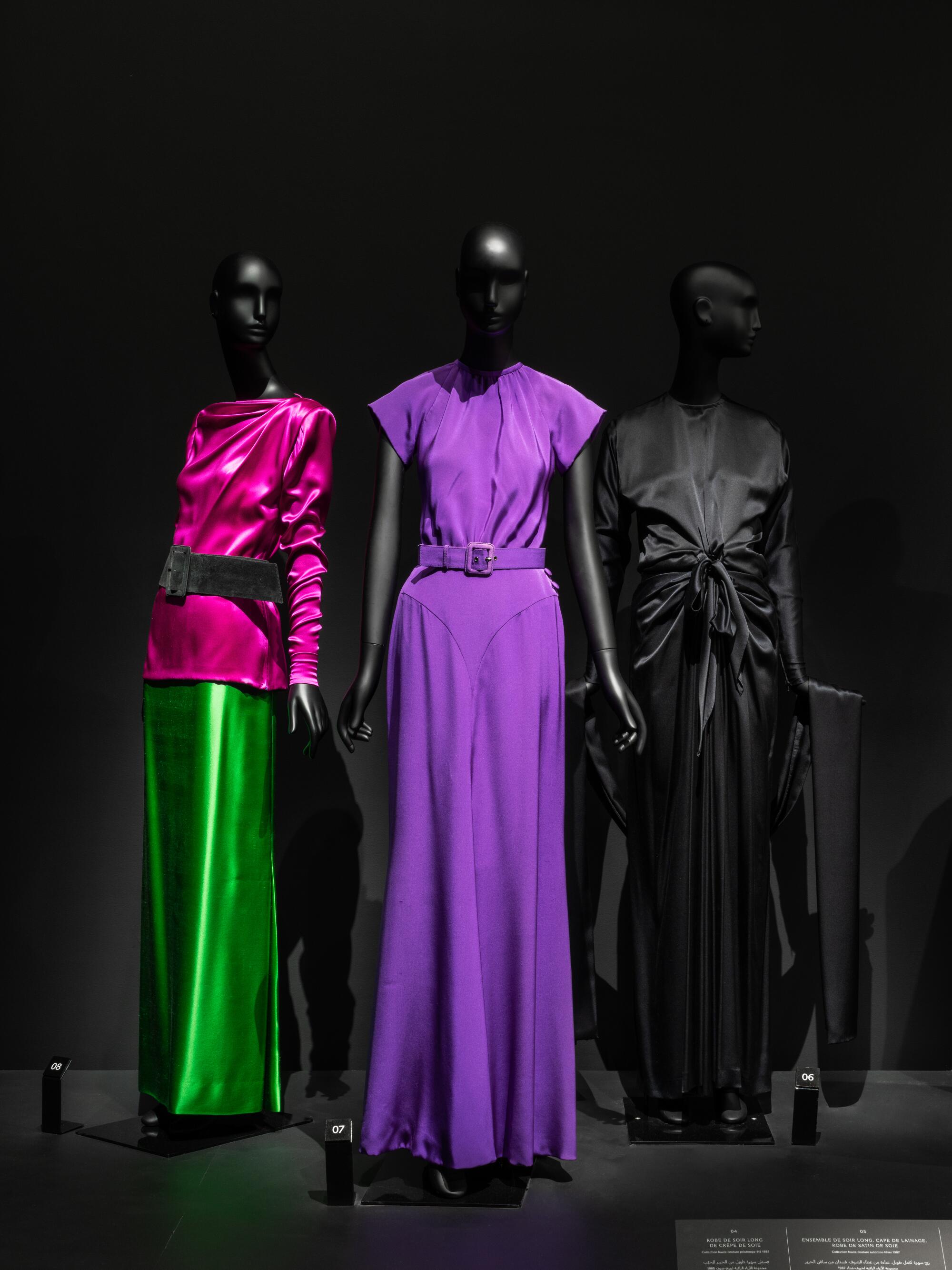 Mannequins wearing long draped dresses