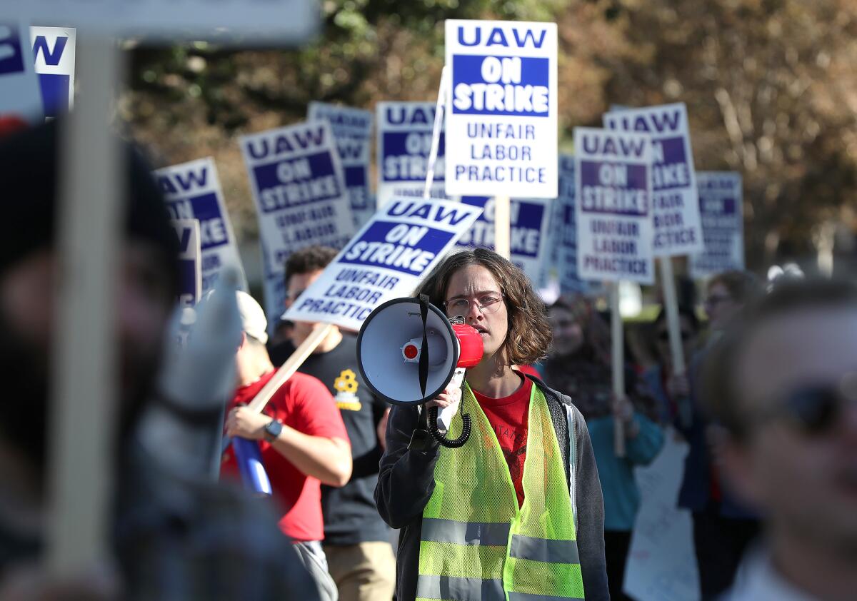 UC Irvine students walk the campus Monday in support of 48,000 unionized academic workers across the UC system.