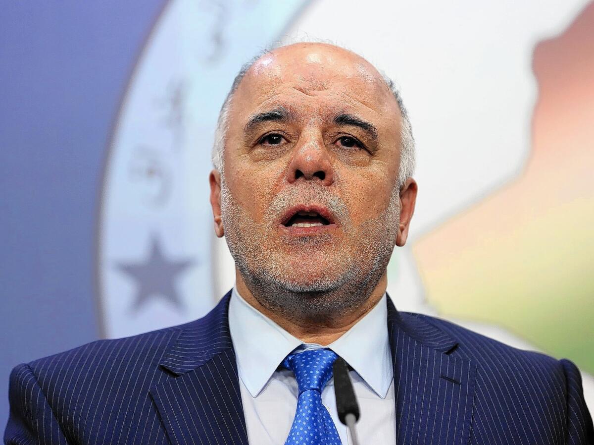 Haider Abadi speaks to reporters in Baghdad in July 15.