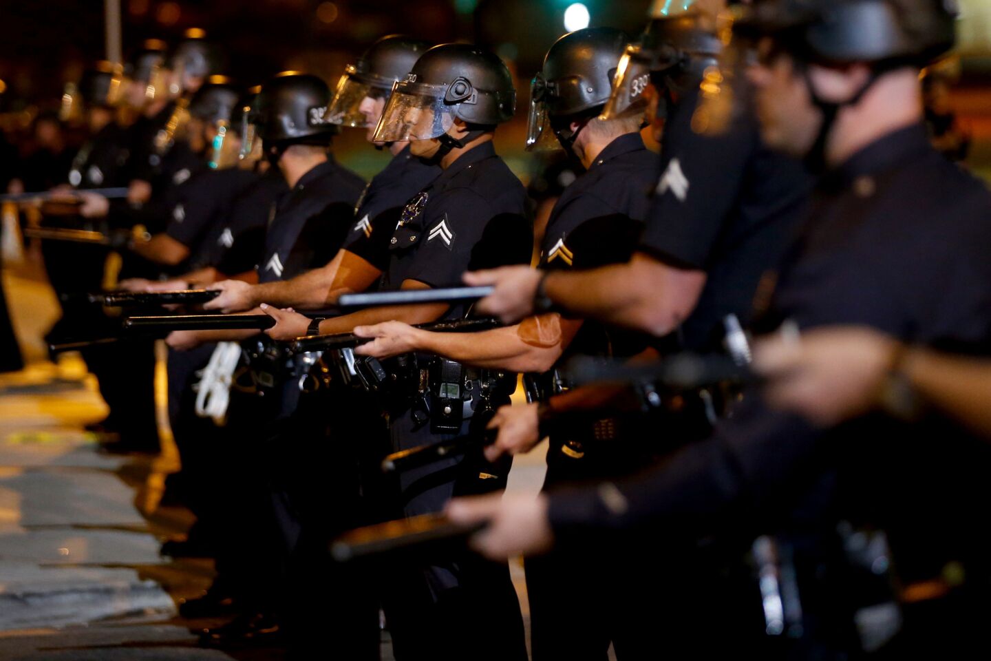 Police disperse the crowd along Western Avenue and 107th Street in Los Angeles, Calif., on Sunday night. Four activists were arrested by LAPD.