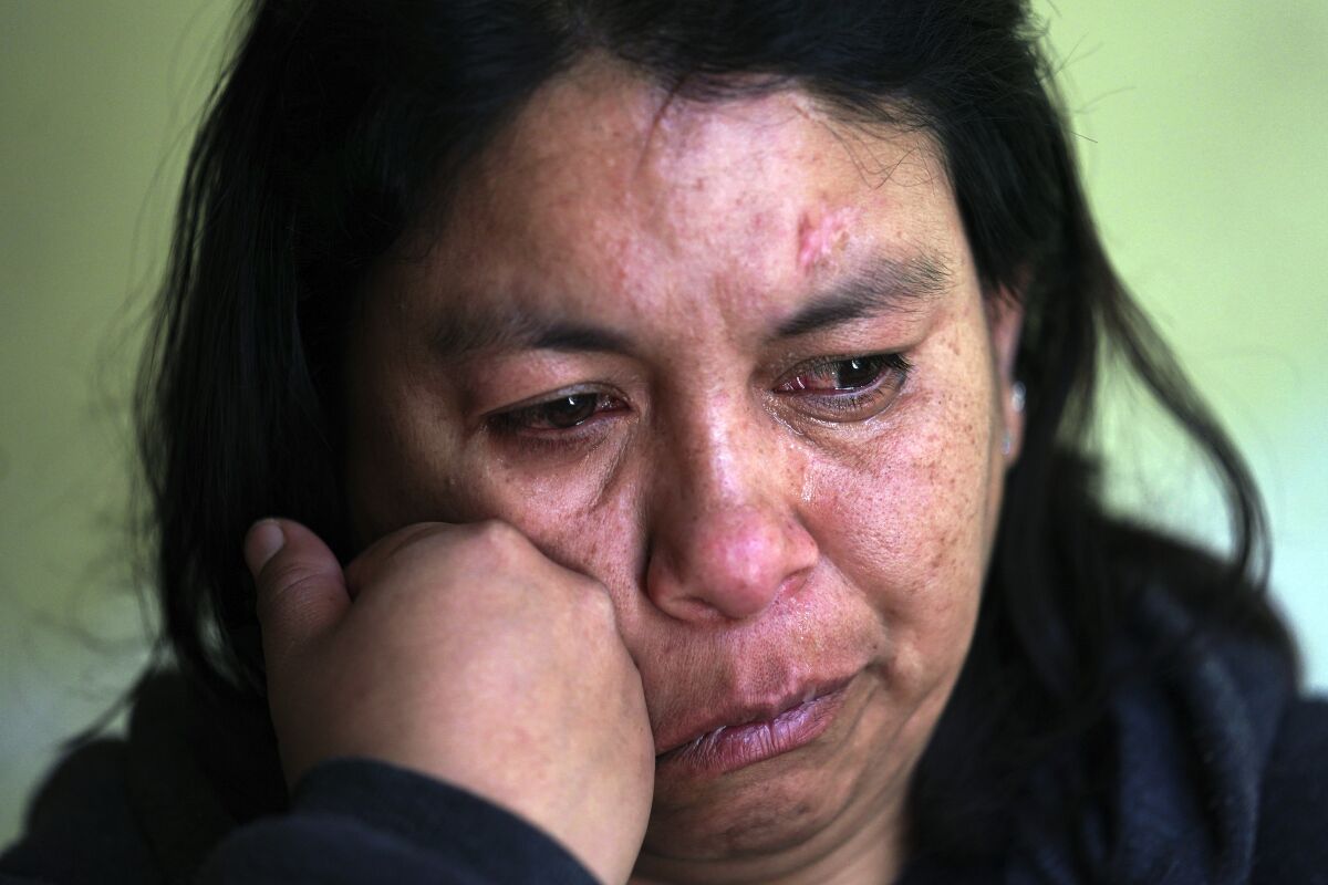 Marisol Garcia Alcantara rests her head on her fist.