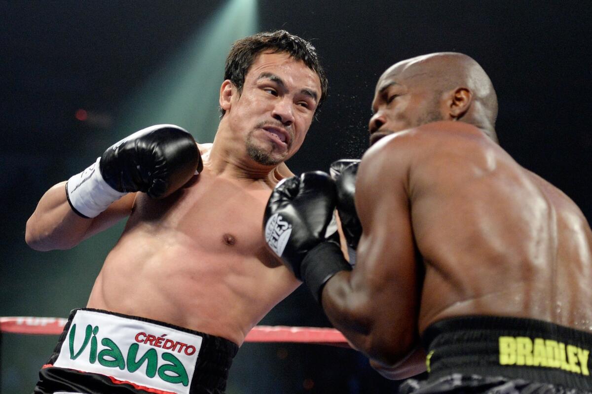 Juan Manuel Marquez delivers a punch during his loss to Timothy Bradley Jr. in October. Marquez, 40, isn't planning to retire just yet.