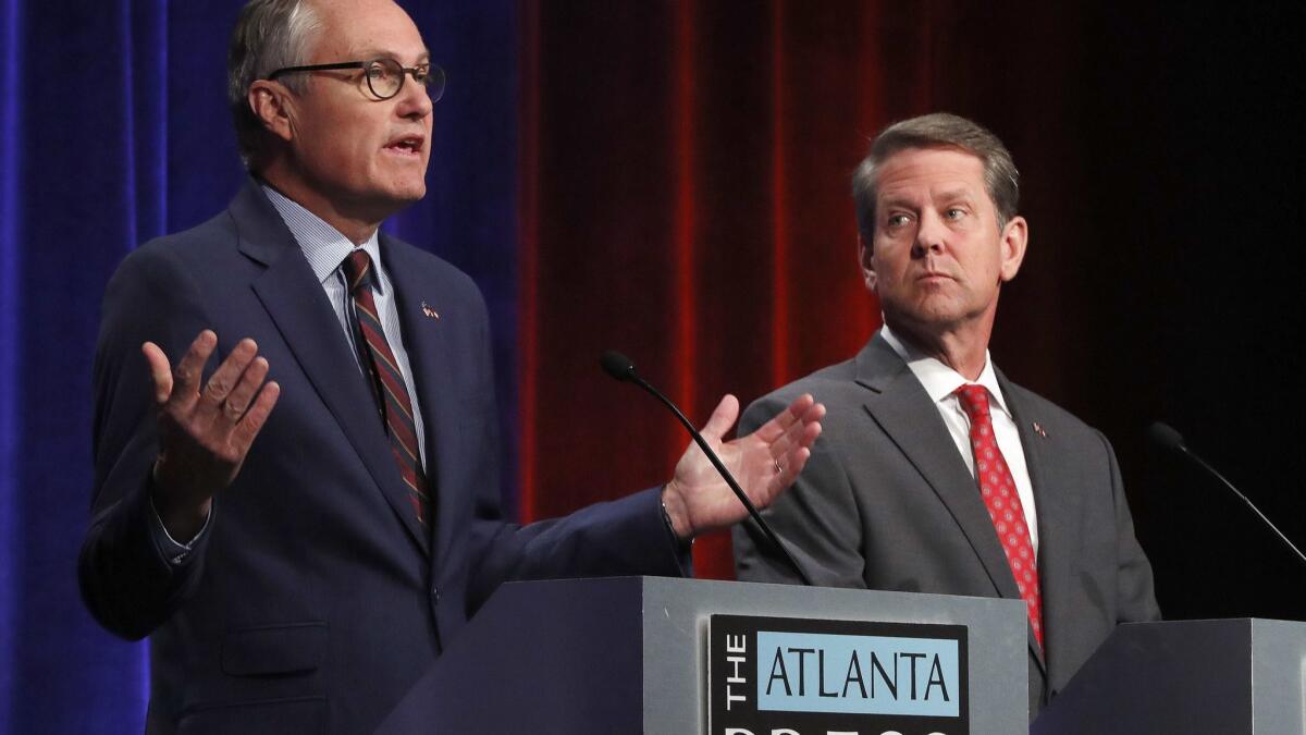 Georgia Lt. Gov. Casey Cagle, left, and Secretary of State Brian Kemp during an Atlanta Press Club debate on July 12.