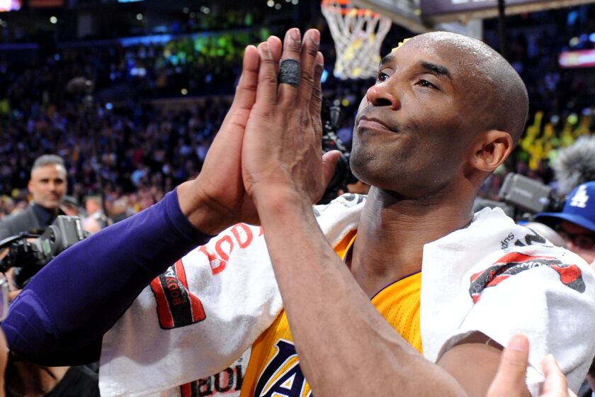 Lakers star Kobe Bryant pays homage to the crowd at Staples Center following the final game of his career on April 13, 2016.