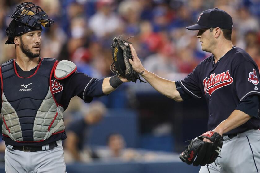 Cleveland Indians' Yan Gomes, left, congratulates teammate Jeff Manship after getting the final out of the eighth inning against the Toronto Blue Jays on July 1.