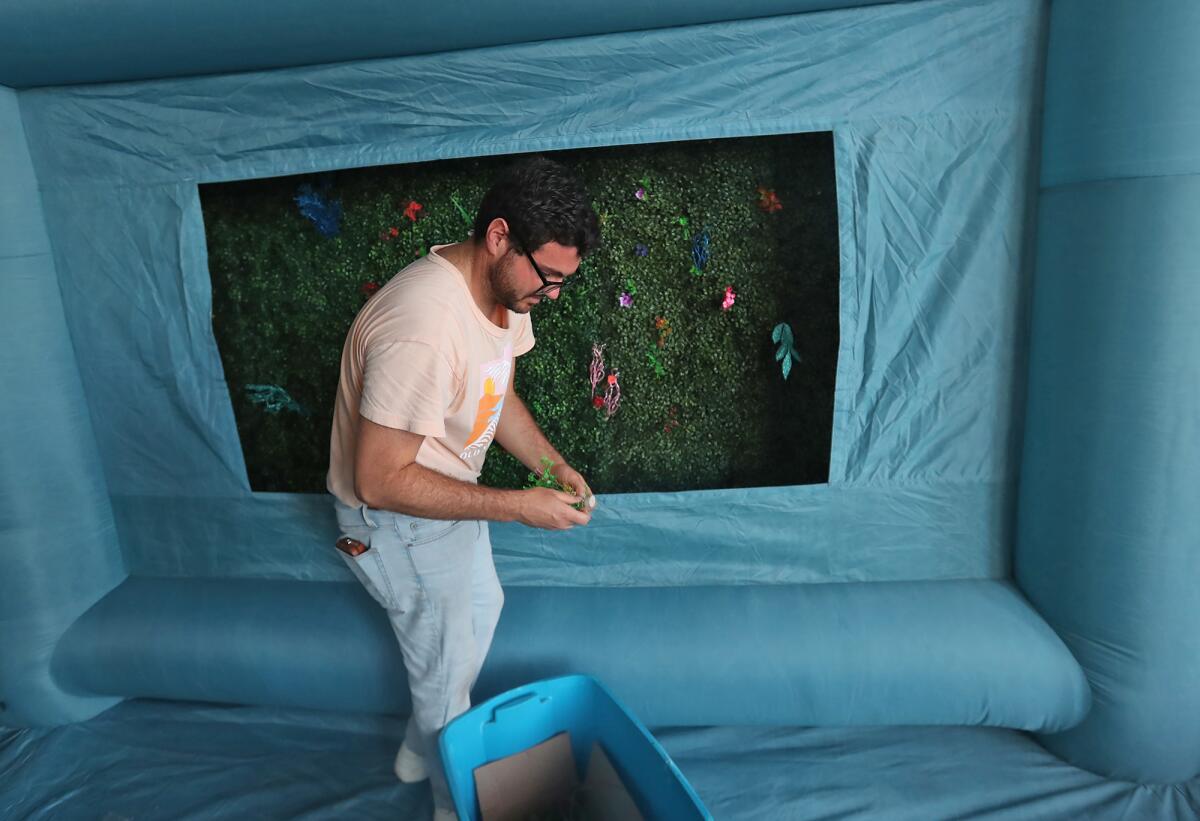Matthew Willmann sets up an exhibit during preparations for the upcoming O.C. Fair on Friday afternoon.