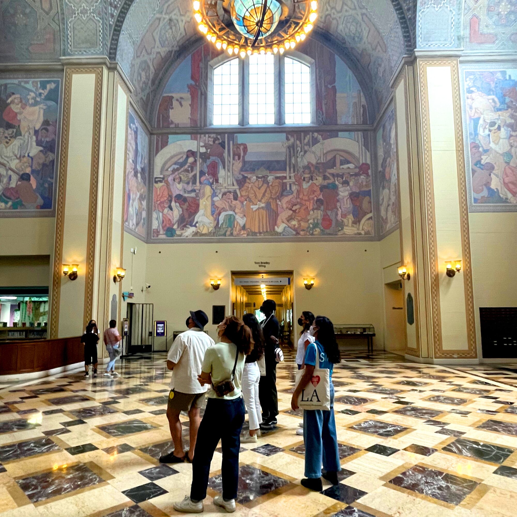 A photo of a tour group inside an ornate old building.