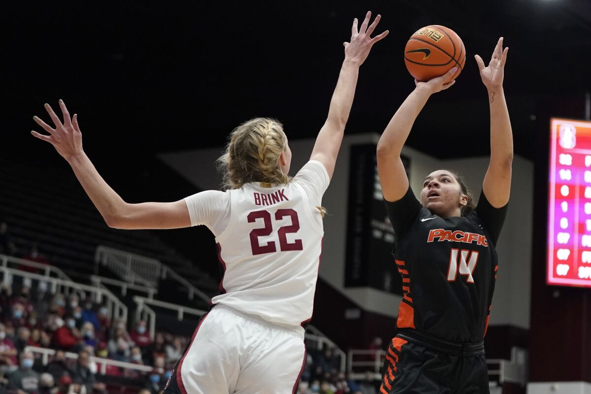 Pacific center Elizabeth Elliott (14) shoots against Stanford forward Cameron Brink (22) during the first half of an NCAA college basketball game in Stanford, Calif., Sunday, Dec. 12, 2021. (AP Photo/Jeff Chiu)