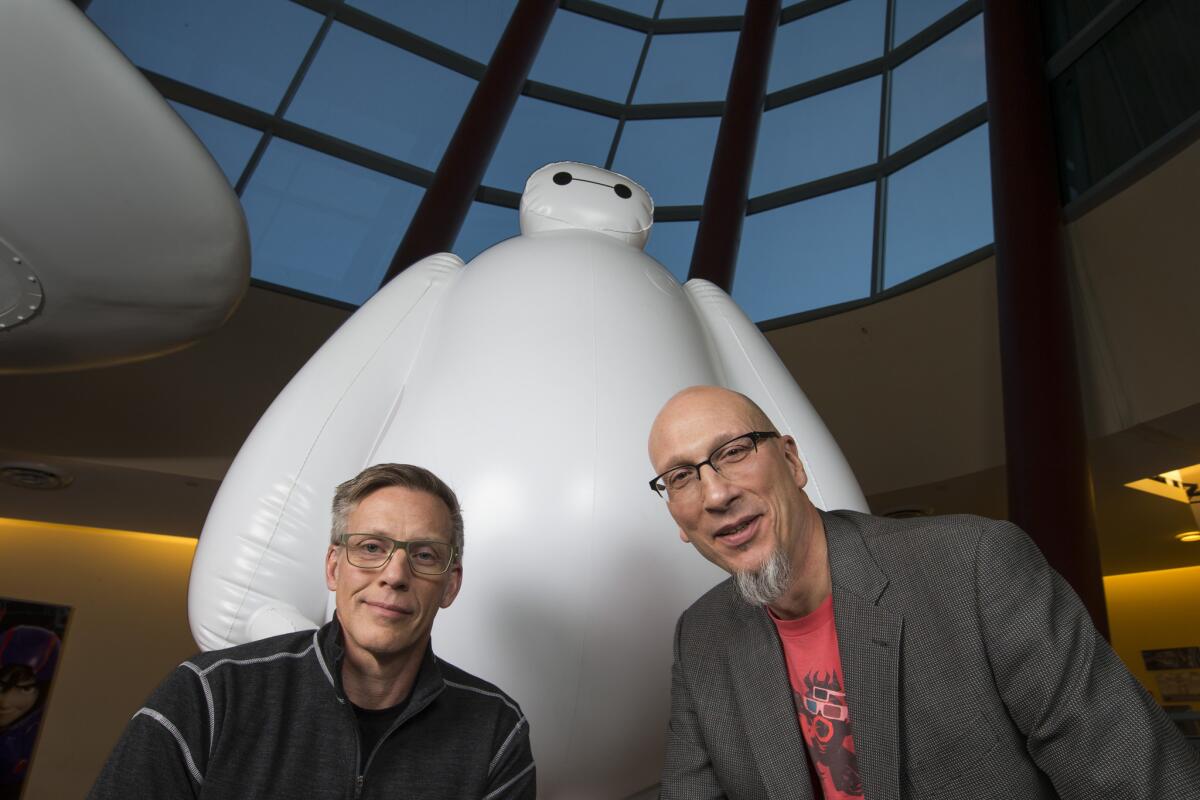 Disney Animation Chief Technology Officer Andy Hendrickson, left, and "Big Hero 6" producer Roy Conli pose with the Baymax character at Walt Disney Animation Studios in Burbank.