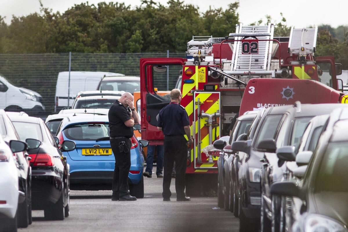 Emergency responders at the scene of a private plane crash that killed three members of Osama bin Laden's family in Hampshire, England.