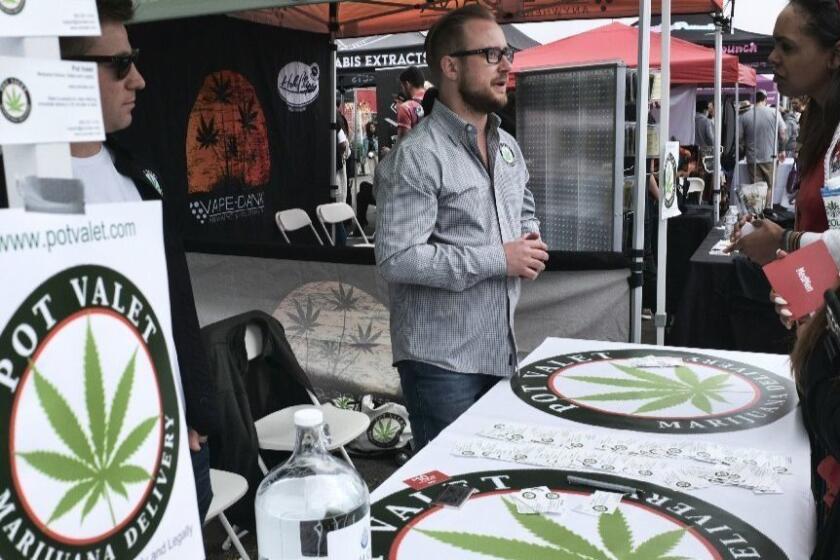 This March 31, 2018 photo shows a booth advertising a delivery service for cannabis at the Four Twenty Games in Santa Monica, Calif. Through a series of active lifestyle events, The 420 Games works to break down the stereotypes that have been built up during the era of cannabis prohibition. (AP Photo/Richard Vogel)