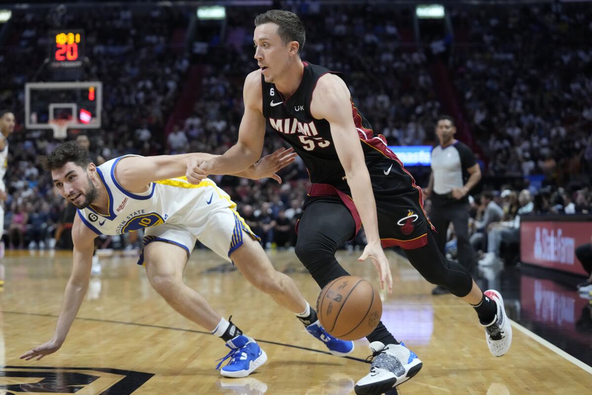 FILE - Miami Heat forward Duncan Robinson (55) drives to the basket past Golden State Warriors guard Ty Jerome (10) during the second half of an NBA basketball game at FTX Arena, Nov. 1, 2022, in Miami. The Heat and Miami-Dade County decided Friday, Nov. 11, 2022, to terminate their relationship with FTX on the same day the cryptocurrency exchange filed for bankruptcy. The building had been called FTX Arena since June 2021, and a 19-year, $135 million sponsorship agreement between FTX and the county was just getting started. (AP Photo/Wilfredo Lee, File)